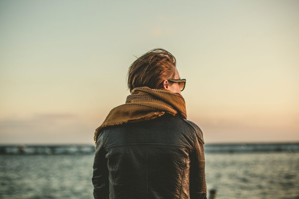 Women looking out at the sunset on the sea